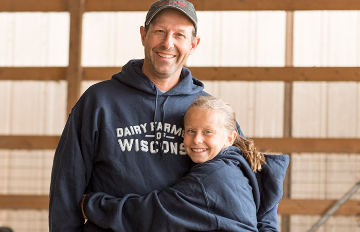 Dairy Farmer and Daughter in Barn