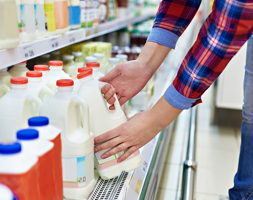 Consumer with choosing milk.
